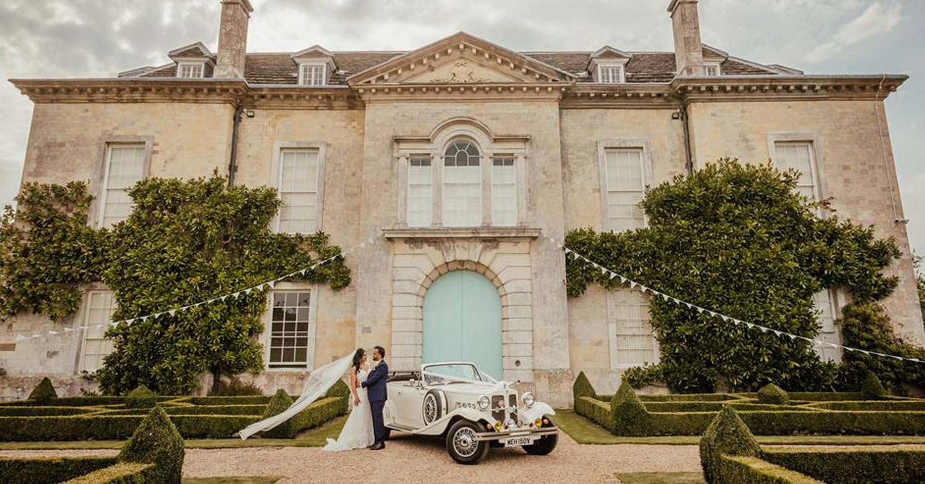 Newly married couple in front Firle Place